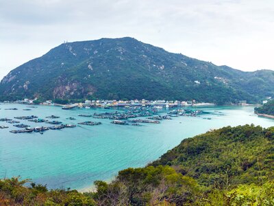 Landscape view of green Lamma Island and blue waters surrounding with cloudy sky, Hong Kong