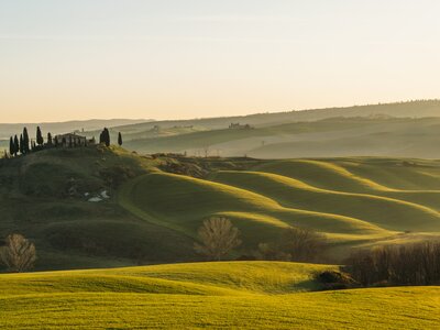 Rolling hills of Tuscany, Italy, bathed in evening light