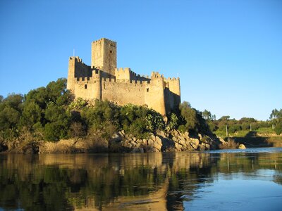 Almourol Castle viewed from Tagus River on sunny clear blue sky day, Portugal