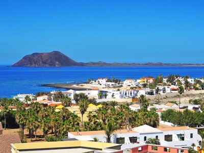 A view of Lobos Island in the distance from Corralejo town in Fuerteventura, Canary Islands, Spain, Europe