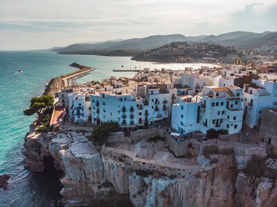 White houses near cliff edge of the Spanish city of Peniscola, province of Castellon, Valencian Community, Spain.