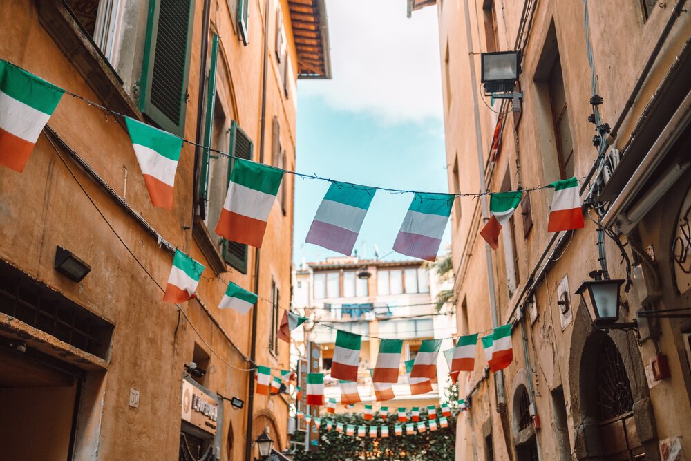 Holiday in the Italian city of streets with Italian flags and ancient buildings. Pisa, Italy