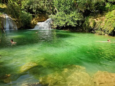 Swimming in a pool beneath a waterfall, Guanayara, Cuba