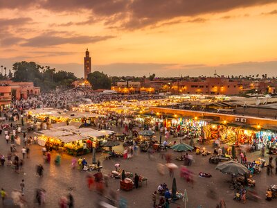 Evening light over bustling Jemea el fna market square in Marrakech, Morocco