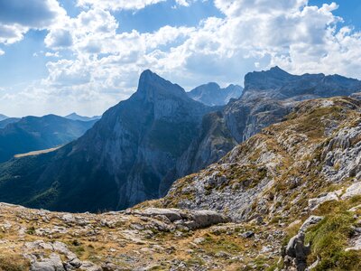 Mountainous landscape of Picos De Europa with hikers in far distance walking on ridge, Spain