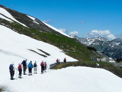 Ramble Worldwide walking group passing melted snow path on mountain in Austria