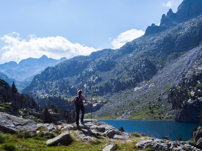 Young hiker woman on walking holiday in Vall de Boi in Aiguestortes and Sant Maurici National Park, Pyrenees, Spain