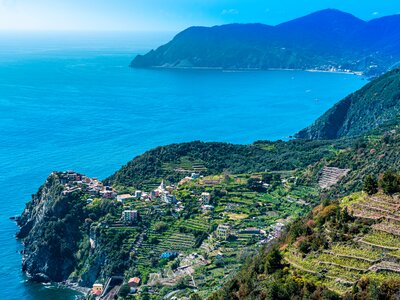 Cinque Terre coastal area with Corniglia Village in far distance, Cape Punta Mesco in background Liguria, Italy