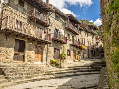 Traditional stone building facade along street in Rupit, Spanish town of Osona, northeast of the region and east of the Sierra de Cabrera, Catalonia, Spain