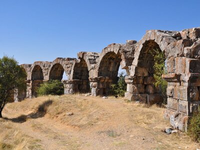 Aqueducts in Pisidia Antiocheia on sunny day with clear blue skies, Turkey