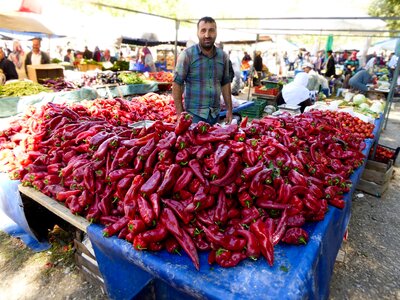 Man selling red peppers at St Paul's Market, Turkey