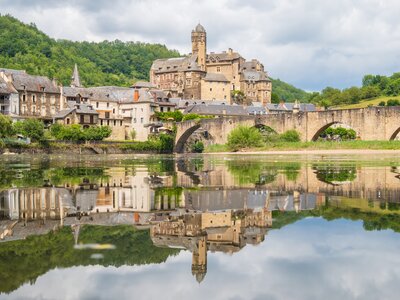 Estaing village, castle and medieval bridge over Lot river, Aveyron, France