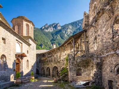 Monastery of Agios Dionysios in Olympus with mountains and clear blue sky in background during sunny day, Greece, Europe