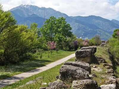 Ancient Greek stone wall built alongside pathway leading towards Mount Olympus, Greece