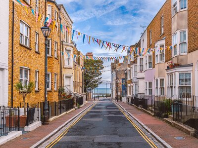 Addington Street with colourful bunting hung across from house to house toward the sea, Ramsgate