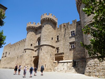 Group walking towards Palace of the Grand Master of the Knights of Rhodes, Greece