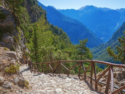 Mountainous landscape by descending stone pathway in National Park Samaria Gorge, hiking trail, Crete, Greece