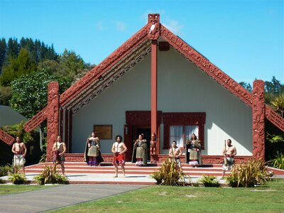 Maori culture demonstration outside traditional house, New Zealand