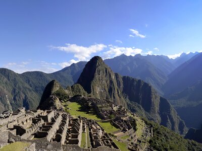 Panorama of Machu Pichu with ancient Inca village atop mountain in mountainous landscape, Peru, South America