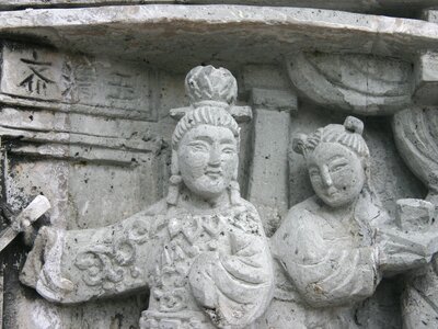 Detailed stone carvings of people on exterior of Tin Hau Temple, Hong Kong