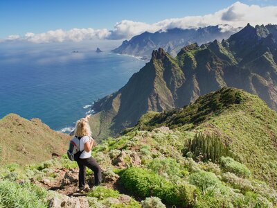 Woman hiker admiring coastal scenery in Tenerife, Canary Islands, Spain