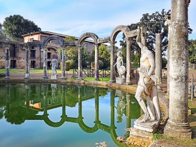 Hadrian's Villa, Canopus pool surrounded by Greek sculptures with reflection in water, Tivoli, Italy