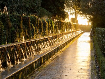 The Hundred Fountains aligned following pathway casted with golden sunlight, Villa D'Este Italian Renaissance garden, Tivoli, Italy