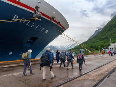 Ramble Worldwide walking group exiting Fred Olsen Bolette cruise ship docking bay and walking towards Norwegian fjords, Norway, Europe