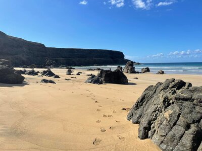 Sand footprints at beach on sunny day, Fuerteventura