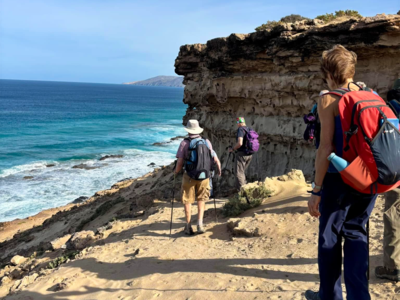 Ramble Worldwide group descending by coastal edge, Fuerteventura