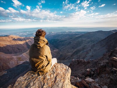 Hiker enjoying view from summit of Mulhacen in Sierra Nevada, Spain