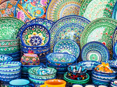 Multicolored ceramic dishes with oriental ornaments at the Siab Bazaar in the ancient city. Samarkand, Uzbekistan