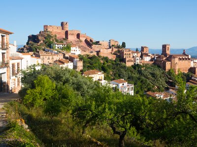 Villafames town in summertime with castle seen atop hill overseeing town, Valencia, Spain