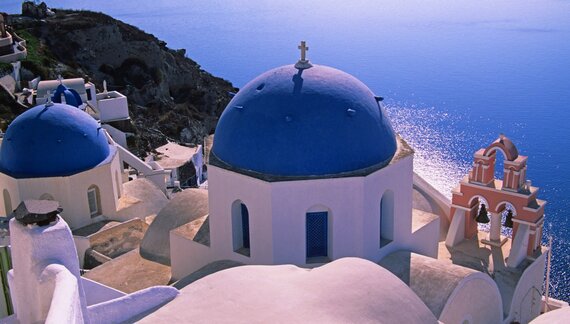 Blue domes and whitewashed walls of traditional buildings on Santorini, Greek Islands